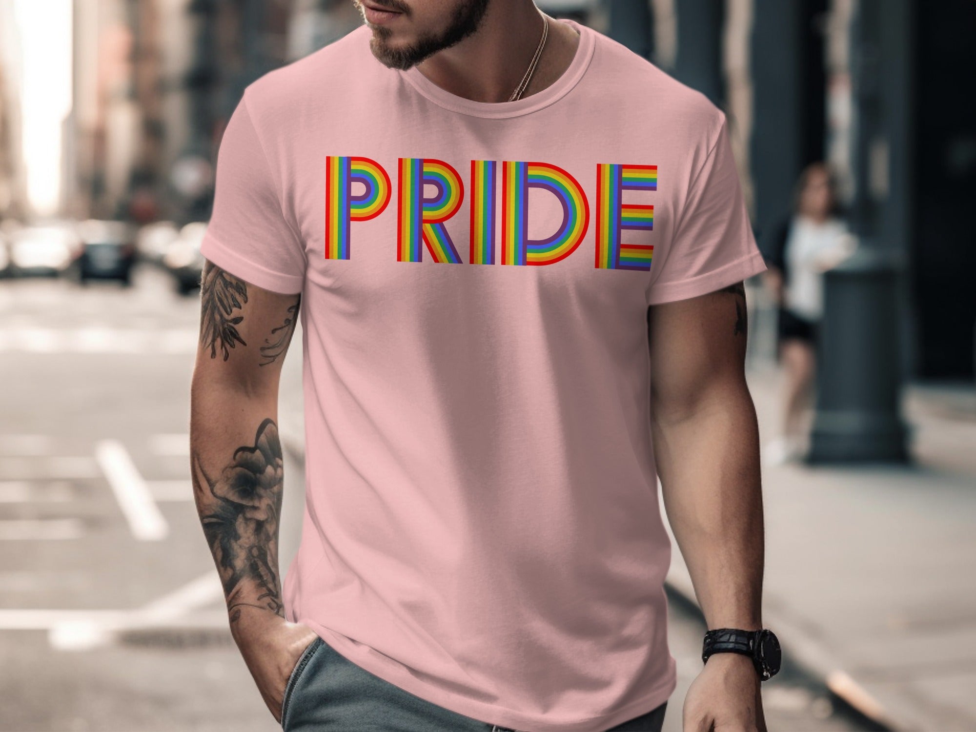 Pink t-shirt with rainbow "PRIDE" text and tattoos.