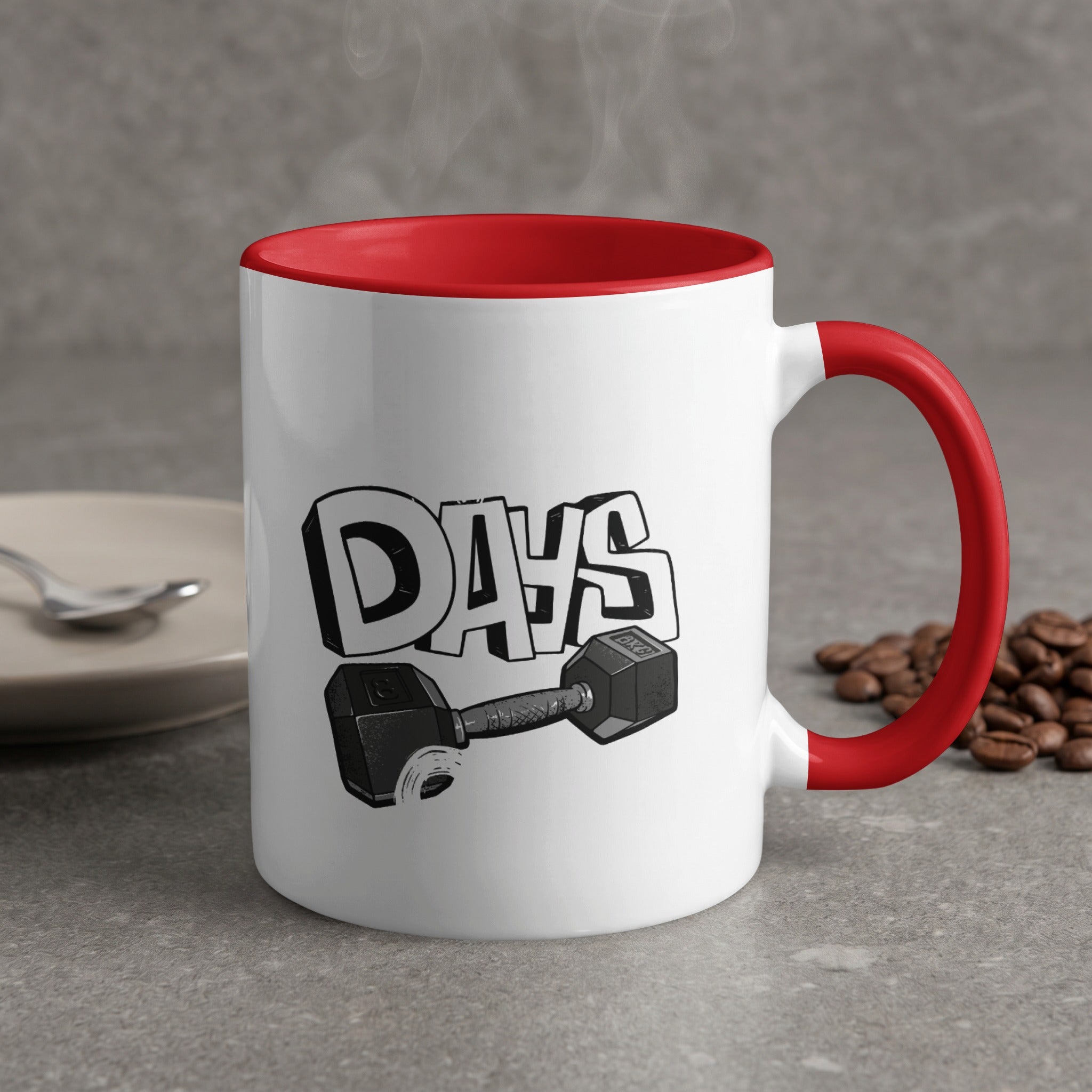 White mug with red handle featuring "DAYS" text and a dumbbell graphic.