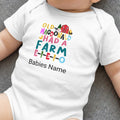 White baby onesie with "Old MacDonald Shad A Farm E-I-E-I-O" text and farm graphics.