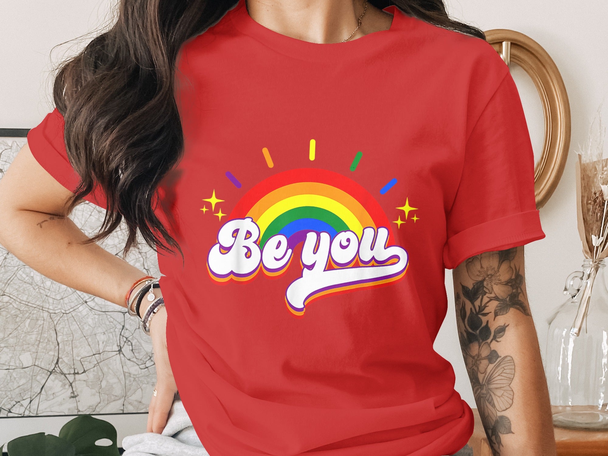 Red t-shirt with rainbow and "Be you" text with yellow stars.