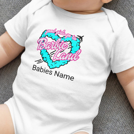 White baby onesie with "good girls go to Barbie Land" heart graphic.