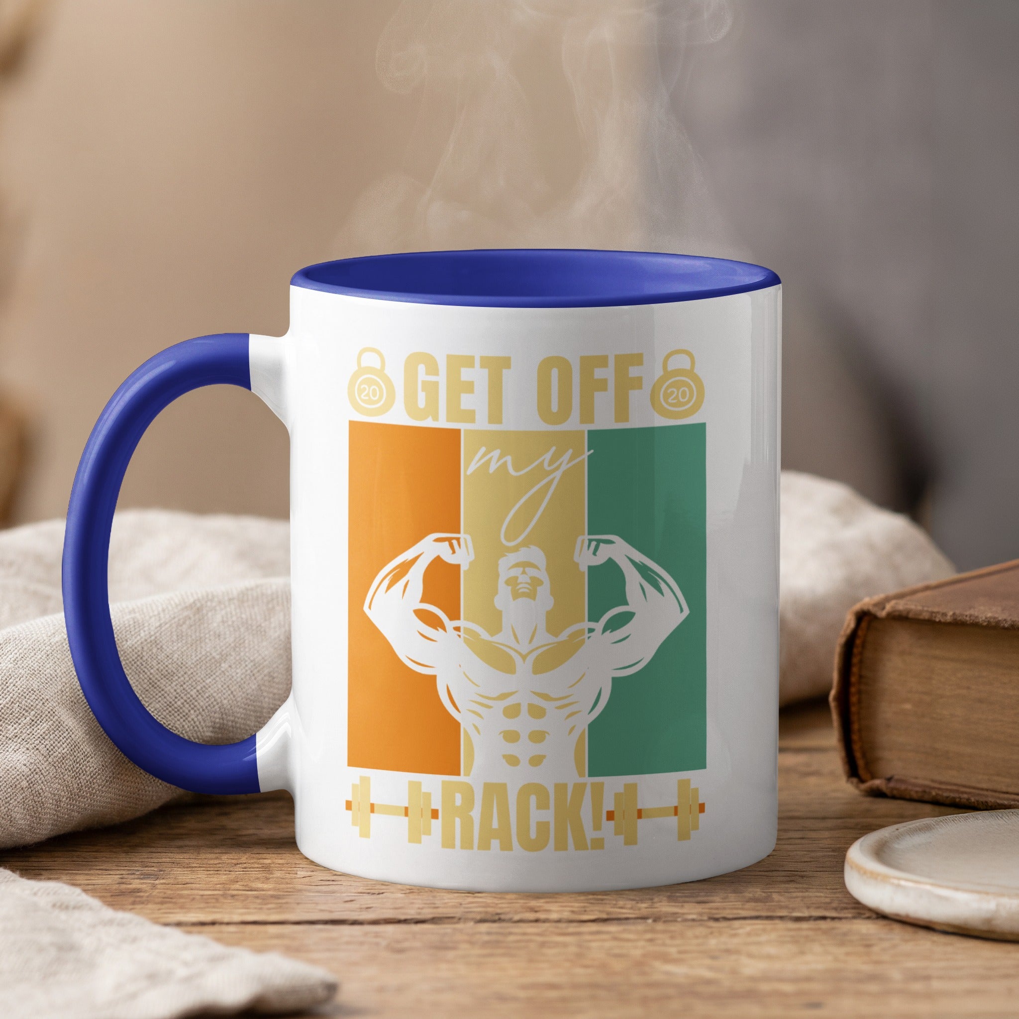 White mug with blue handle, steaming, features muscular silhouette and text "Get Off My Track!".