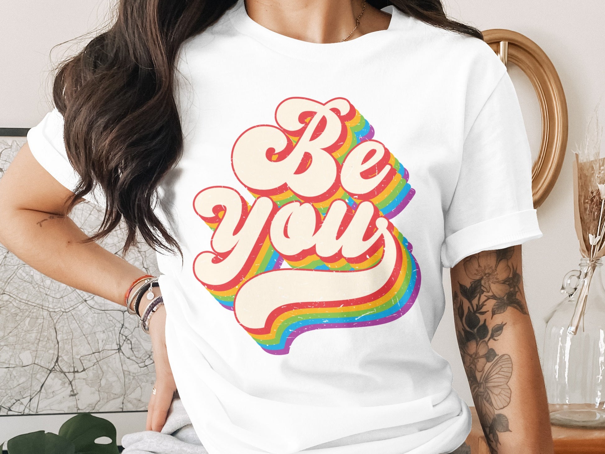 White t-shirt with "Be You" in retro rainbow lettering.