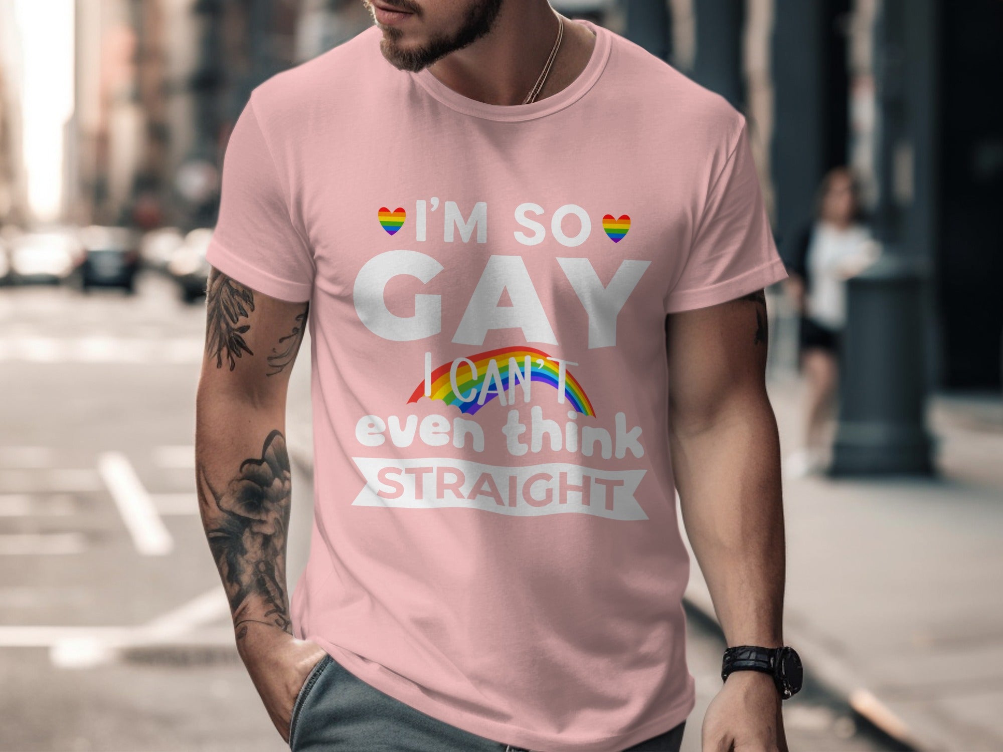 Pink t-shirt with white text "I'M SO GAY I CAN'T EVEN THINK STRAIGHT" and rainbow accents.