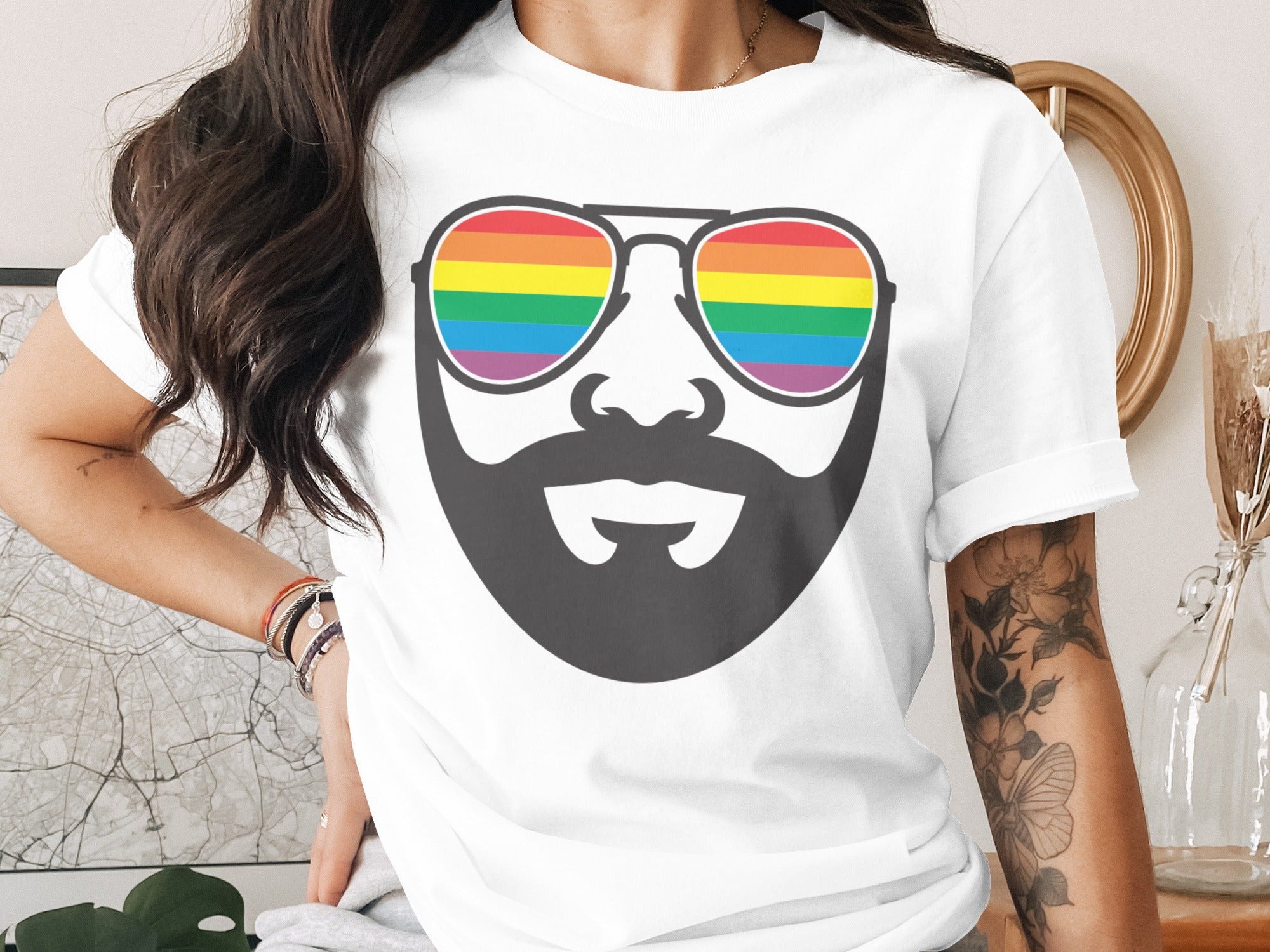 White t-shirt with a graphic of a bearded face wearing rainbow sunglasses.