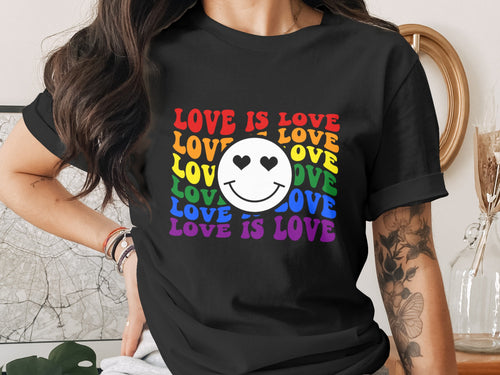 Black t-shirt with rainbow "LOVE IS LOVE" text and a smiley face.