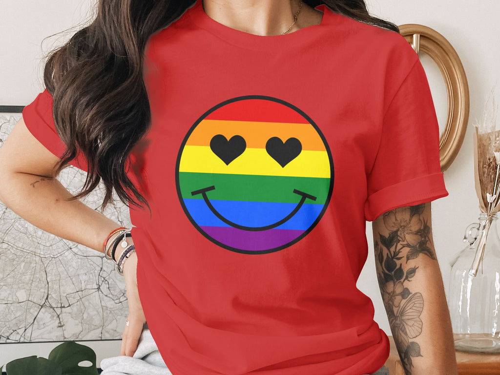 Red t-shirt with a rainbow smiley face graphic with black heart eyes.