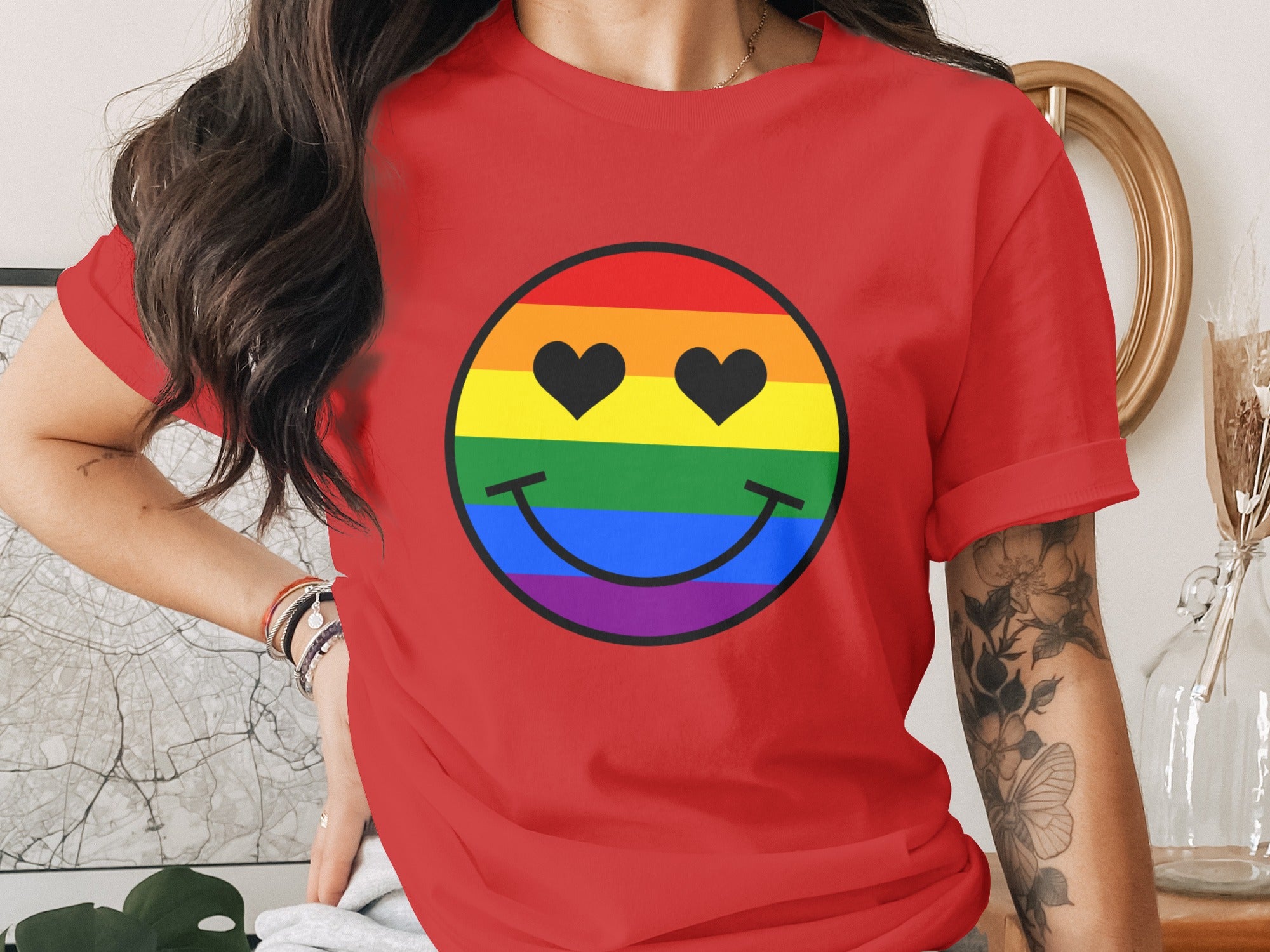 Red t-shirt with a rainbow smiley face graphic with black heart eyes.
