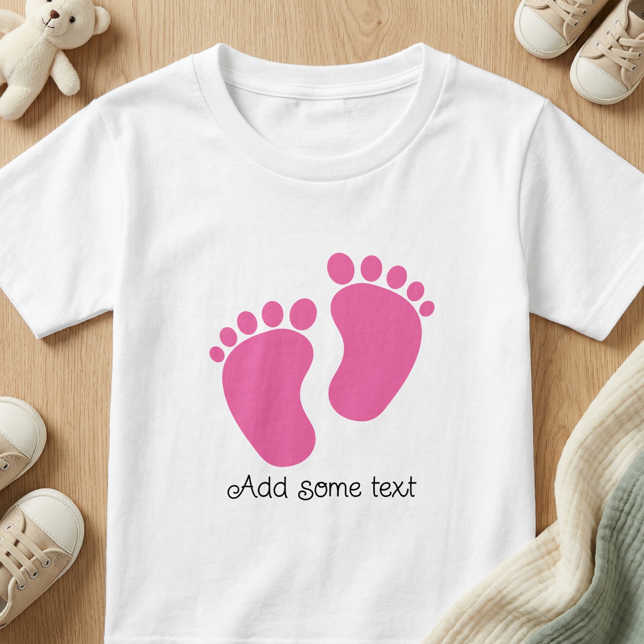 White t-shirt with pink baby footprints and "Add some text"
