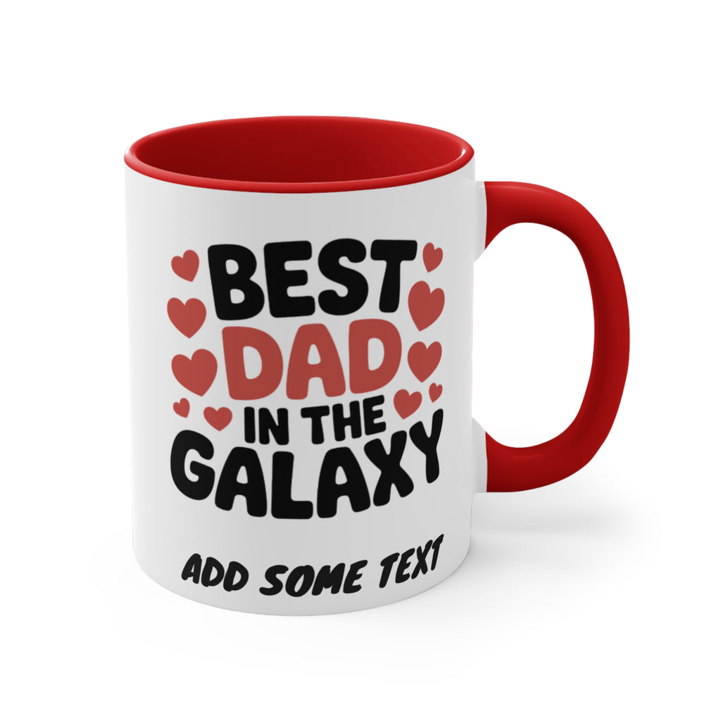 White mug with red interior and handle, featuring "BEST DAD IN THE GALAXY" text and hearts.