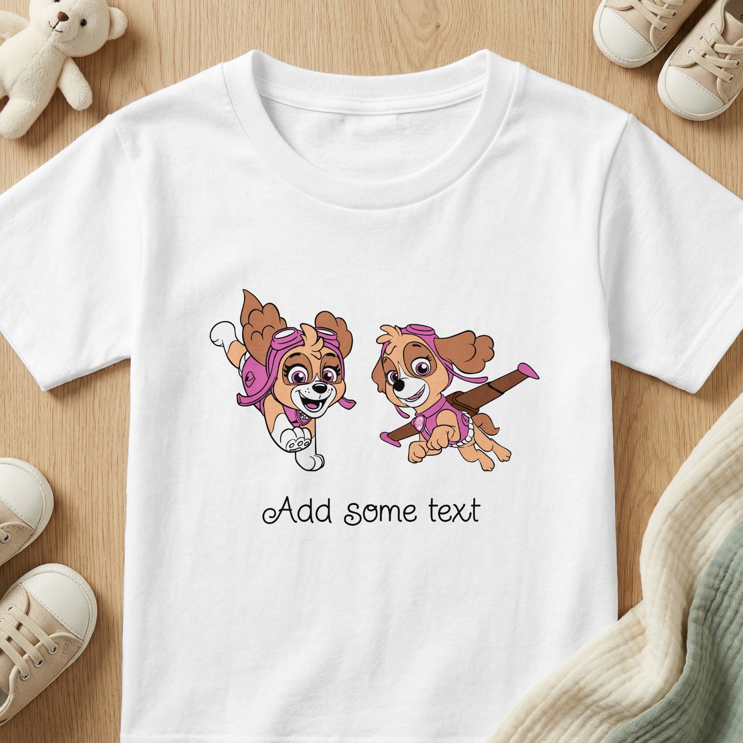 White t-shirt with two cartoon dogs wearing pilot gear and text that says "Add some text".