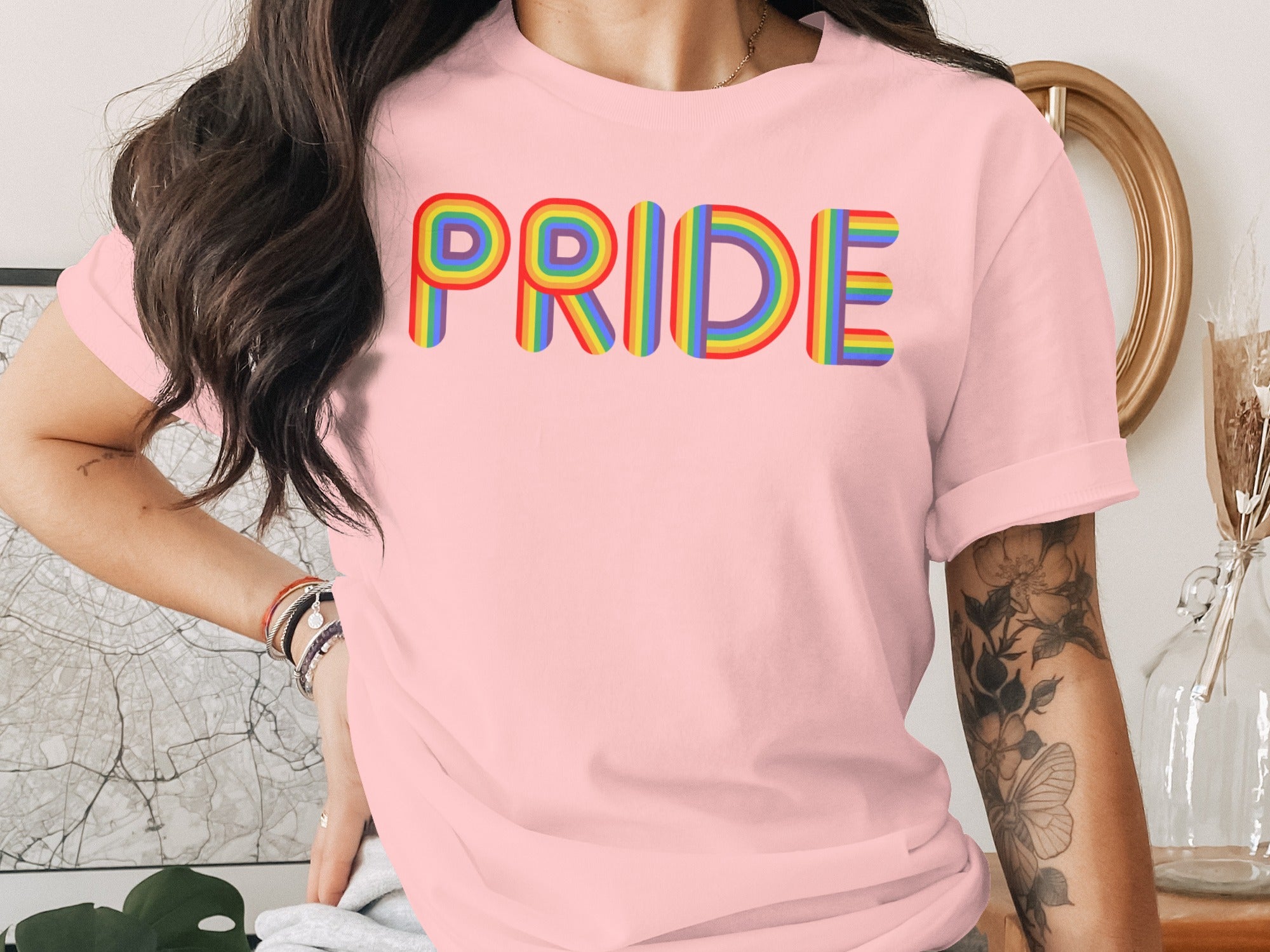 Pink t-shirt with rainbow-striped "PRIDE" text across the chest.