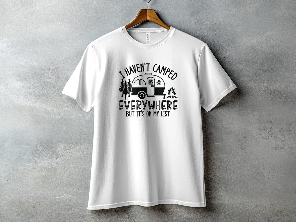 White t-shirt with black graphic reading "I HAVEN'T CAMPED EVERYWHERE BUT IT'S ON MY LIST".