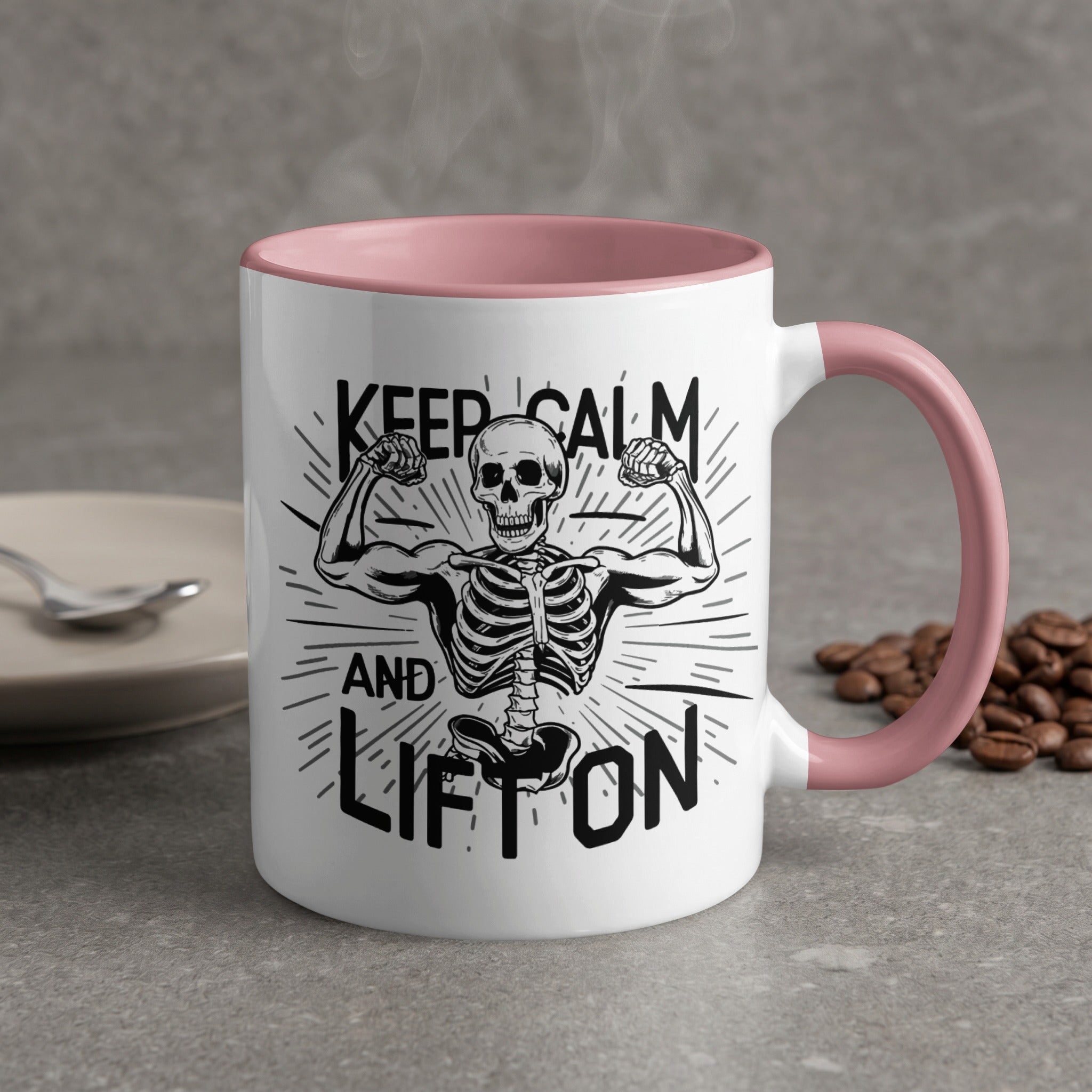 White mug with pink handle, "Keep Calm and Lift On" text, skeleton flexing.
