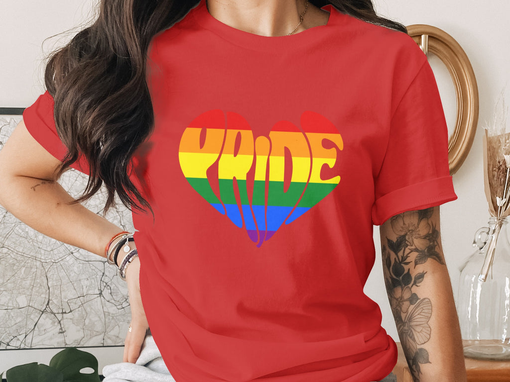 Red t-shirt with a rainbow heart graphic spelling "Pride."