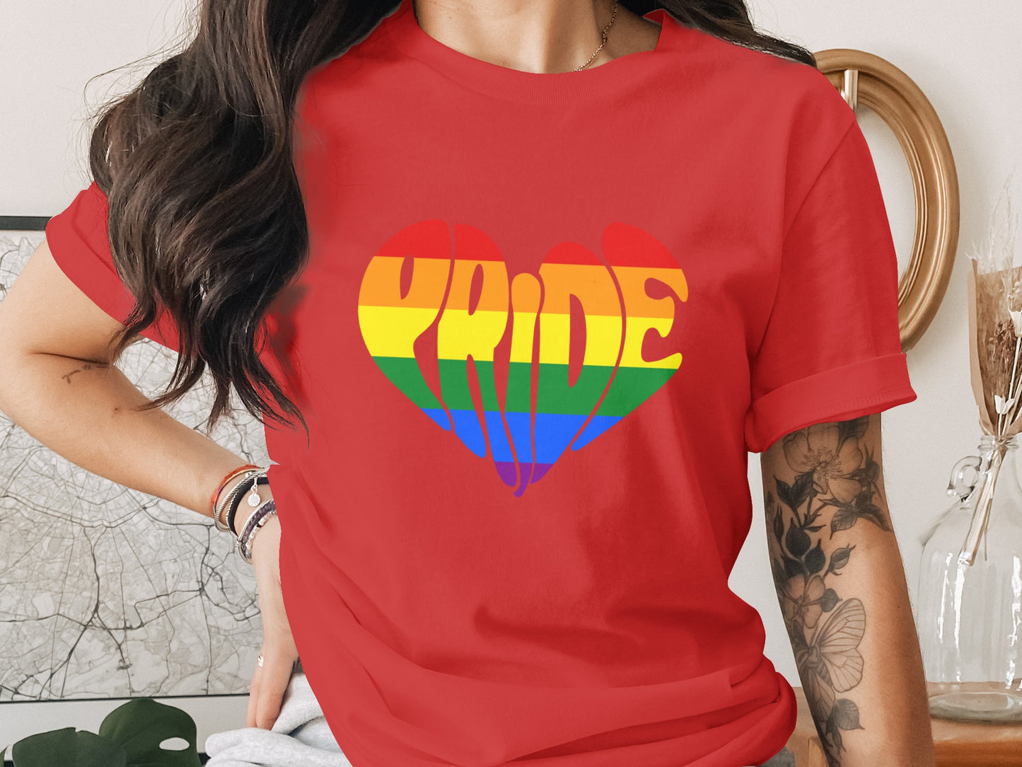 Red t-shirt with a rainbow heart graphic spelling "Pride."