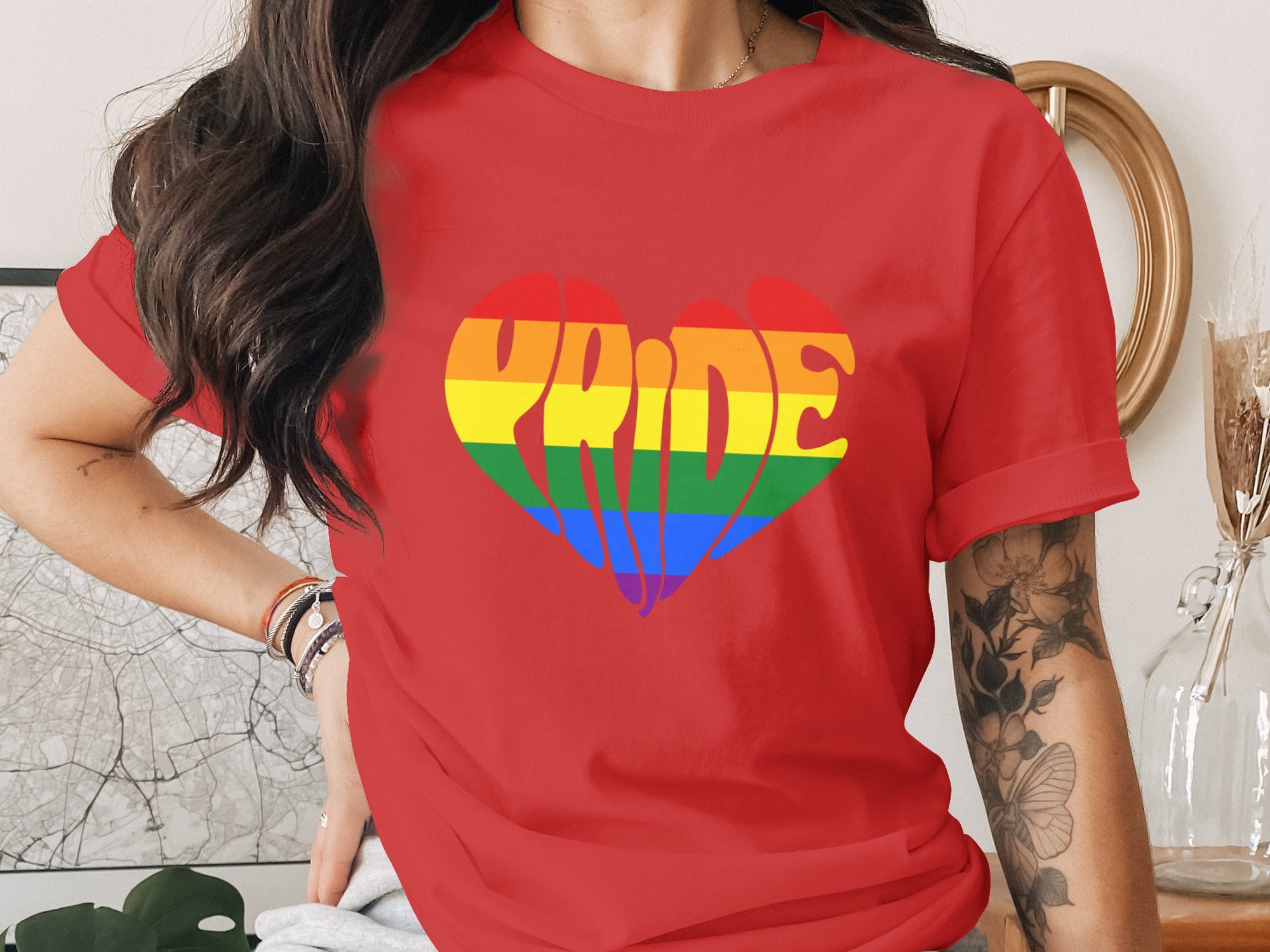 Red t-shirt with a rainbow heart graphic spelling "Pride."