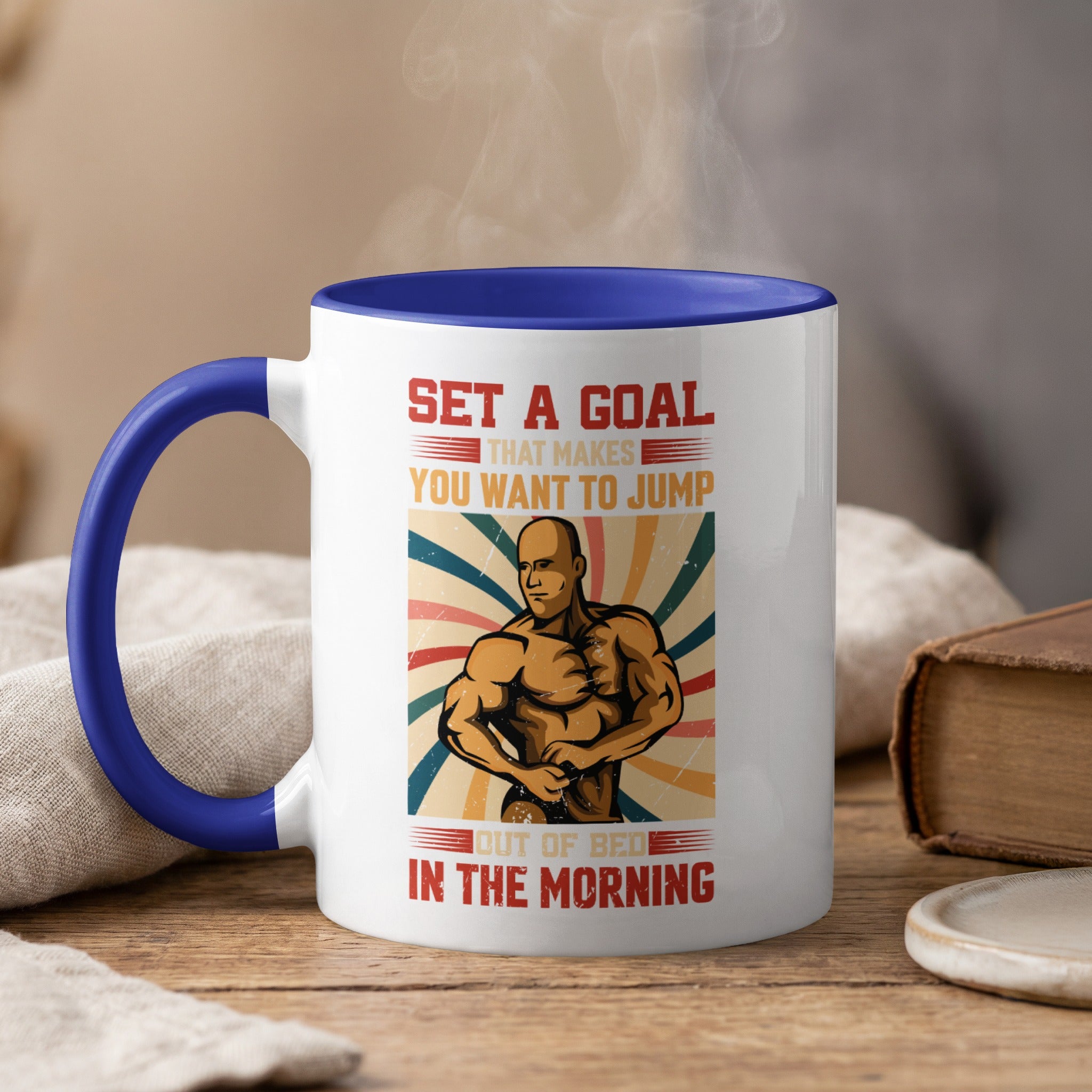 Mug with muscular man illustration and motivational text "Set a goal that makes you want to jump out of bed in the morning."