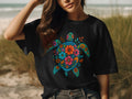Black t-shirt with a colorful floral sea turtle graphic on the front.