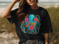 Black t-shirt with a blue octopus and colorful flowers graphic design.