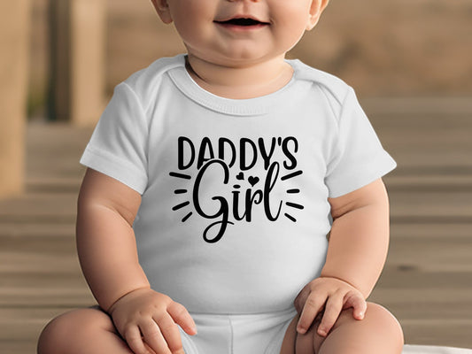 White baby onesie with "Daddy's Girl" in black text.