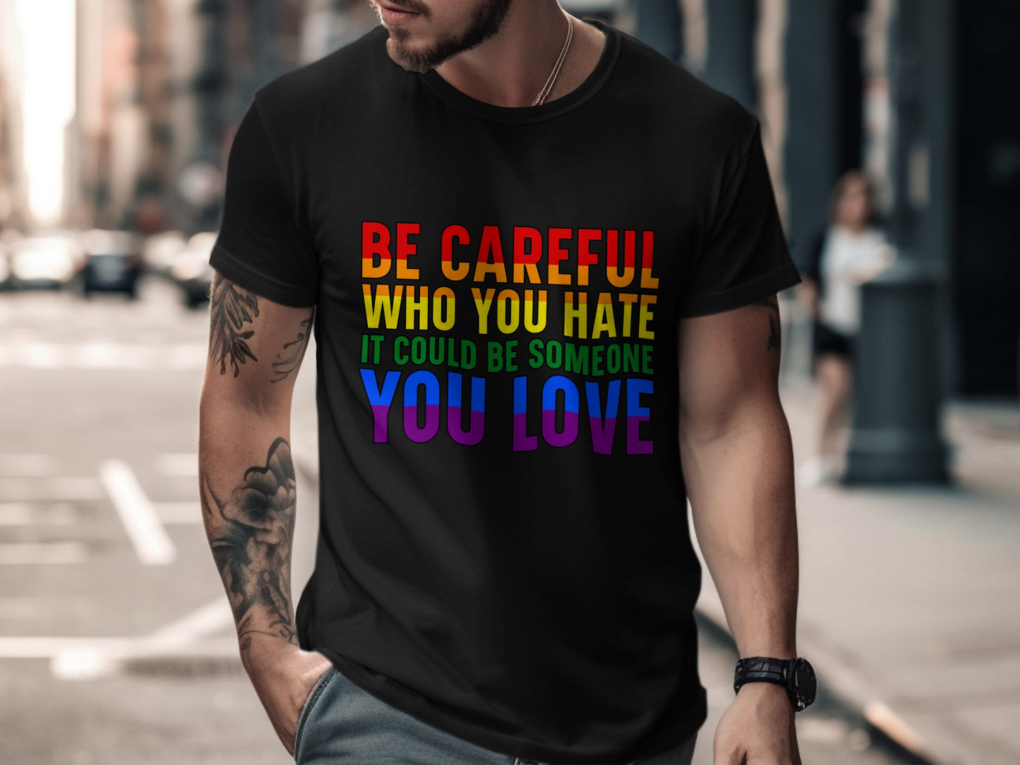 Black t-shirt with rainbow text reading "Be Careful Who You Hate It Could Be Someone You Love".