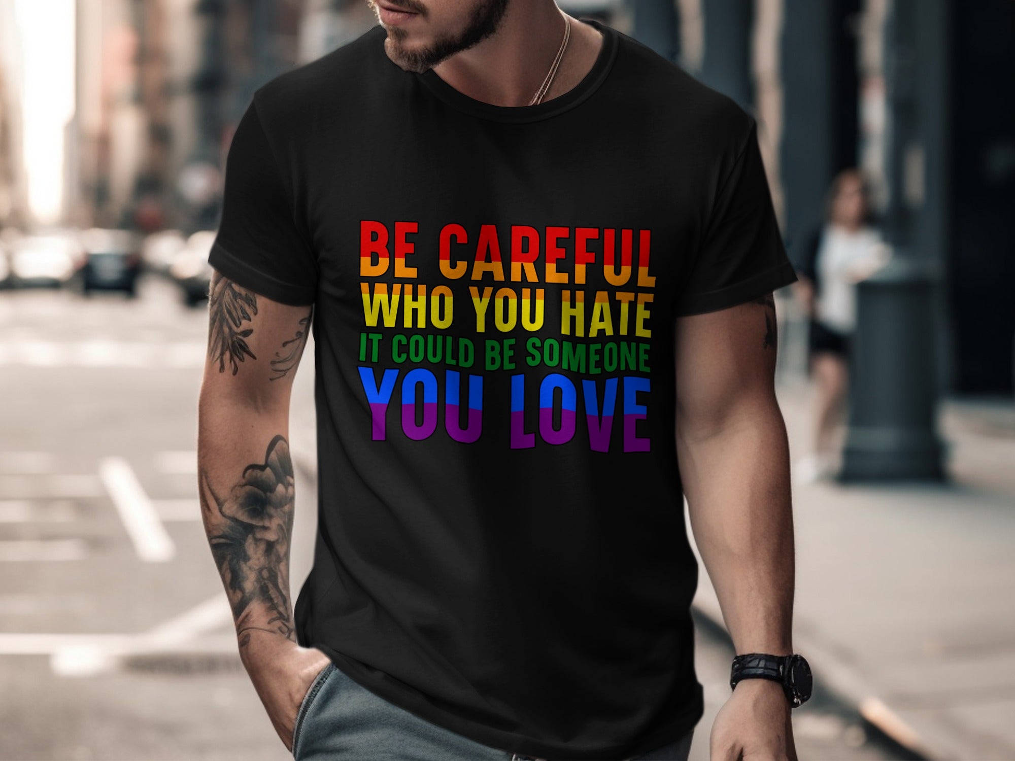 Black t-shirt with rainbow text reading "Be Careful Who You Hate It Could Be Someone You Love".