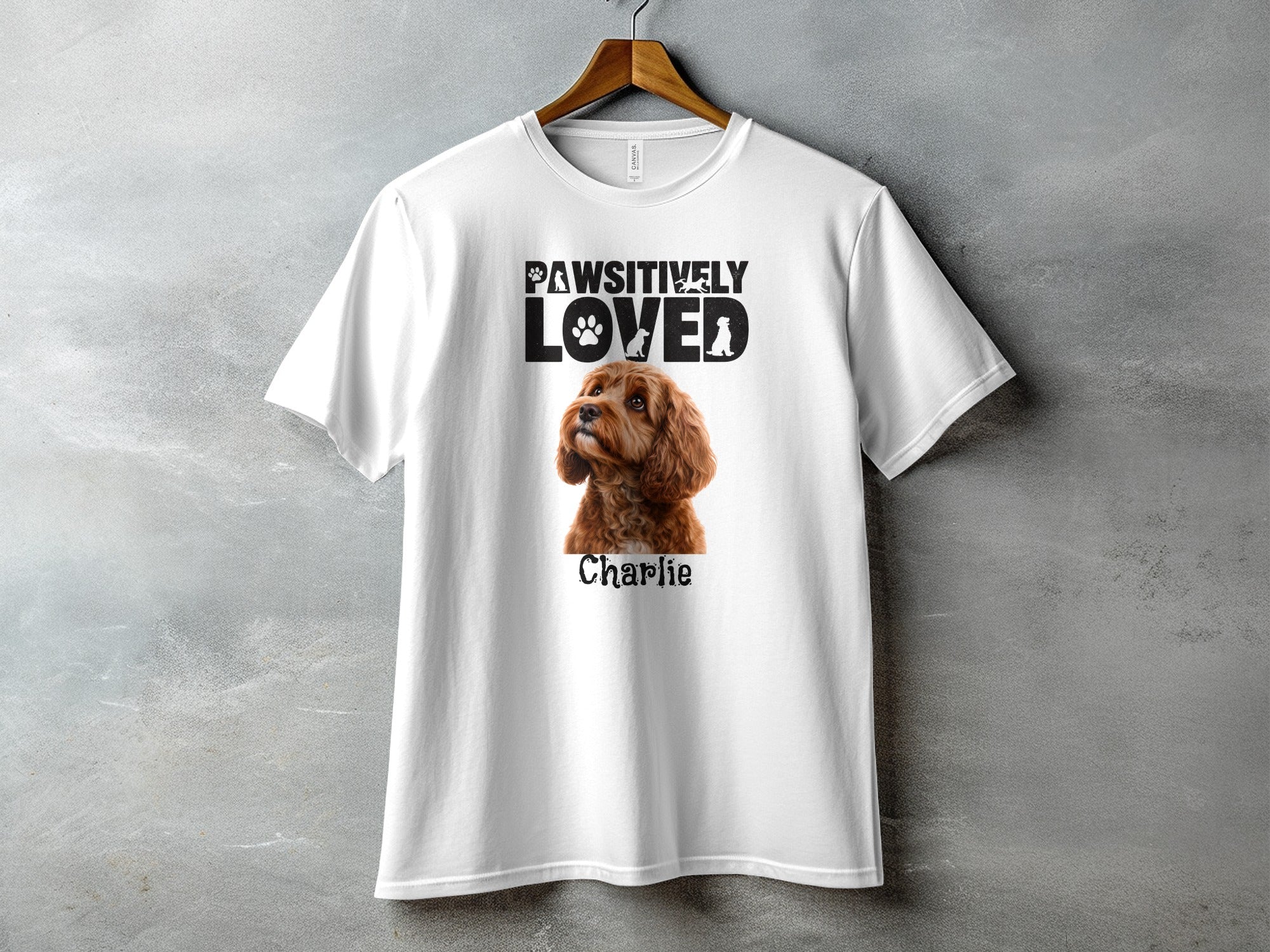 White t-shirt with "PAWSITIVELY LOVED" text and a dog portrait named Charlie.