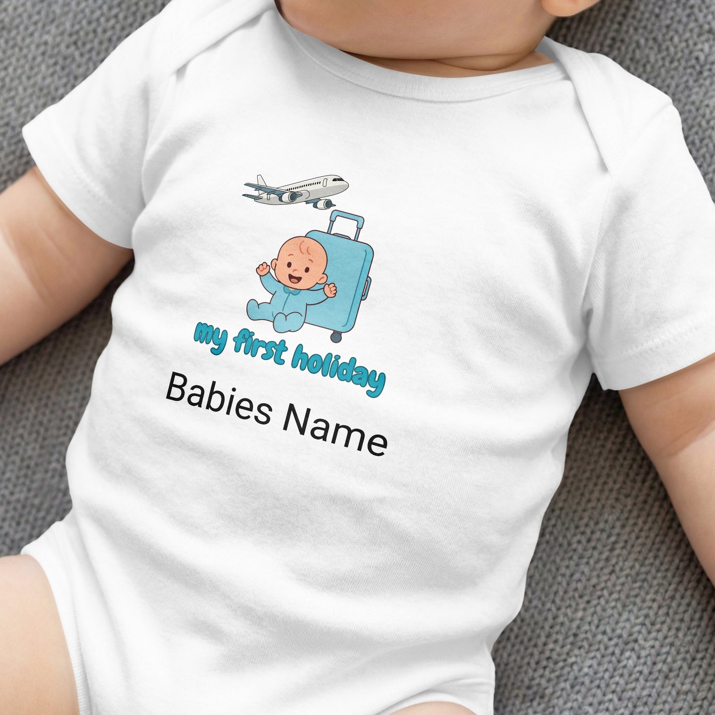Baby bodysuit with airplane, suitcase, and "my first holiday" text.