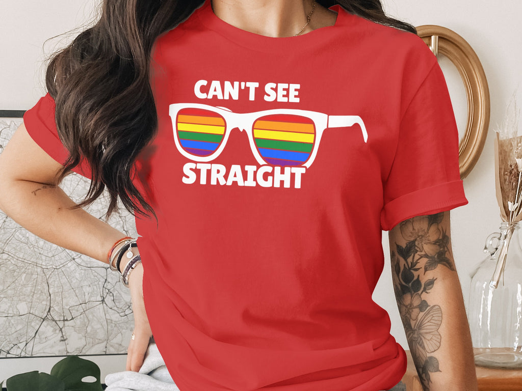 Red t-shirt with text "CAN'T SEE STRAIGHT" and rainbow sunglasses.