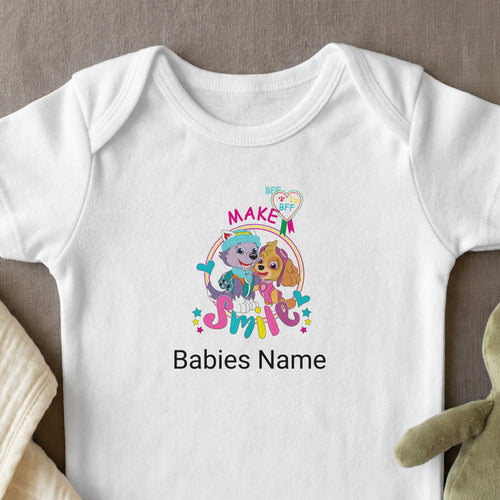 Paw Patrol characters Skye and Everest smiling on a white baby onesie.